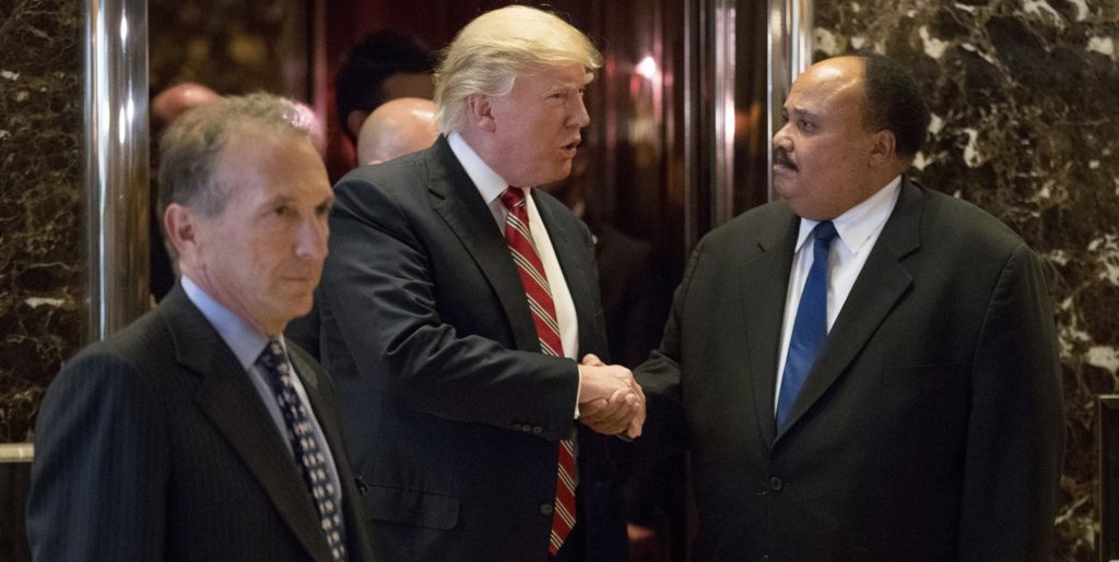 President-elect Donald Trump shakes hands with Martin Luther King III, son of Martin Luther King Jr. at Trump Tower in New York, Monday, Jan. 16, 2017. Also pictured is William Wachtel, left. (AP Photo/Andrew Harnik)