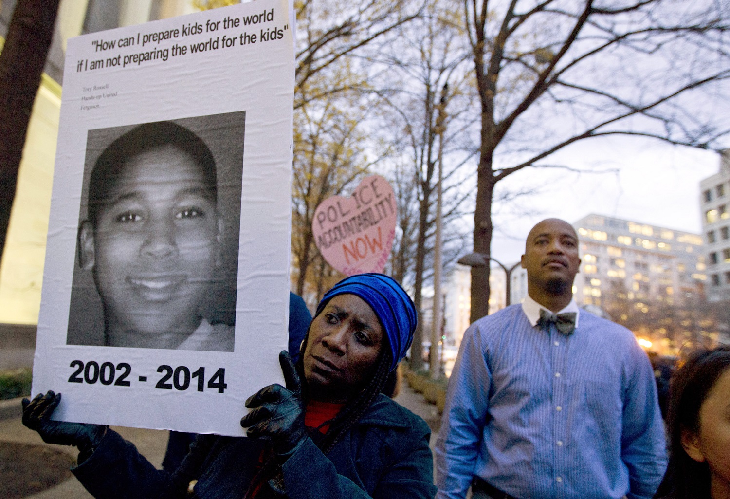 FILE - In a Monday, Dec. 1, 2014 file photo, Tomiko Shine holds up a picture of Tamir Rice during a protest in Washington, D.C. The gazebo where the 12-year-old boy, Rice, was fatally shot by a Cleveland police officer is scheduled to be disassembled. A spokesman for the Stony Island Arts Bank says the shingles will be removed on Wednesday, Sept. 14, 2016, with work continuing into next week. (AP Photo/Jose Luis Magana, File)