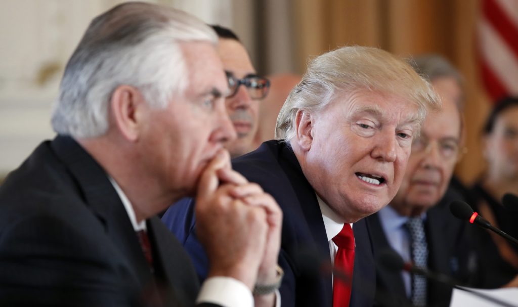In this April 7, 2017, photo, President Donald Trump, joined by Secretary of State Rex Tillerson, left, speaks during a bilateral meeting with Chinese President Xi Jinping at Mar-a-Lago in Palm Beach, Fla. Lambasted for his low-key diplomacy, Tillerson is emerging from the shadows with his leading public role in shaping and explaining the Trump administration's missile strikes in Syria. He now takes on an even higher-profile mission, heading to Moscow this week under the twin clouds of Russia’s alleged U.S. election meddling and its possible support for a Syrian chemical weapons attack. (AP Photo/Alex Brandon)