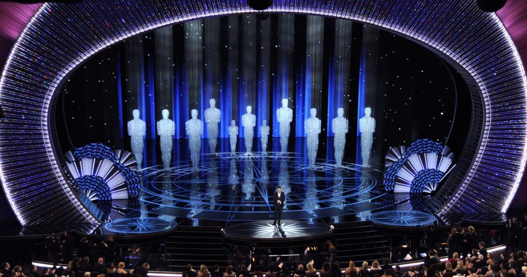 FILE - In this Feb. 26, 2017 file photo, host Jimmy Kimmel appears at the Oscars in Los Angeles. The Academy of Motion Picture Arts and Sciences on Tuesday, May 16, 2017, said Kimmel will return for the 90th Oscars on March 4, 2018. (Photo by Chris Pizzello/Invision/AP, File)
