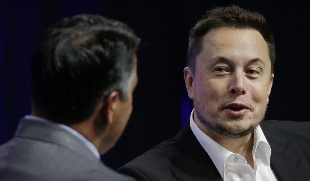 Tesla and SpaceX CEO Elon Musk responds to a question by Nevada Republican Gov. Brian Sandoval during the closing plenary session entitled "Introducing the New Chairs Initiative - Ahead" on the third day of the National Governors Association's meeting Saturday, July 15, 2017, in Providence, R.I. (AP Photo/Stephan Savoia)