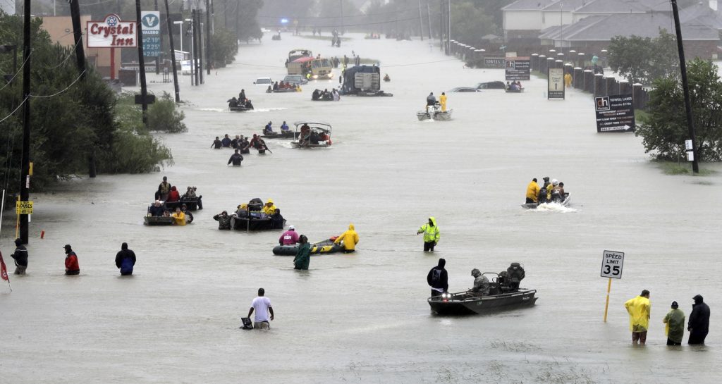 Rescue boats fill a flooded street as flood victims are evacuated as floodwaters from Tropical Storm Harvey rise Monday, Aug. 28, 2017, in Houston. (AP Photo/David J. Phillip)