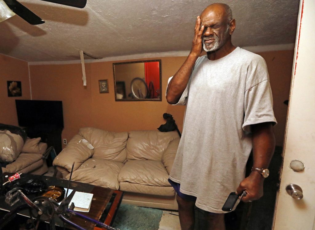 Clarence Johnson of Lake Charles, La., in his home Tuesday, Aug. 29, 2017. Johnson was at home when the flood waters on Legion Street crept into his home, ruining a stereo system, television, and clothes he had stored on the floor of his closets. (AP Photo/Rogelio V. Solis)
