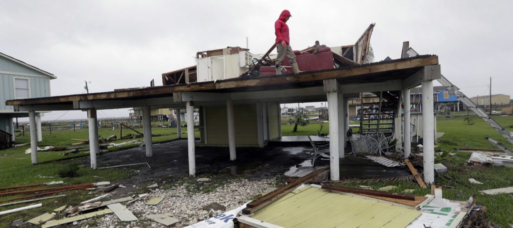 Evelyn Perkins inspects her home which was destroyed in the wake of Hurricane Harvey, Monday, Aug. 28, 2017, in Rockport, Texas. (AP Photo/Eric Gay)