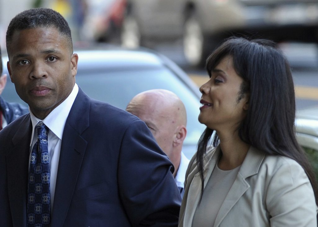 FOR USE AS DESIRED, YEAR END PHOTOS - FILE - Former Illinois Rep. Jesse Jackson Jr. and his wife, Sandra, arrive at federal court in Washington, Wednesday, Aug. 14, 2013, to learn their fates when a federal judge sentences the one-time power couple for misusing $750,000 in campaign money on everything from a gold-plated Rolex watch and mink capes to vacations and mounted elk heads. (AP Photo/Susan Walsh, File)