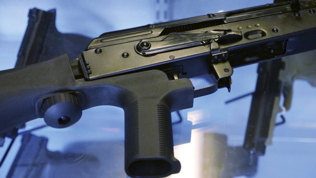 A little-known device called a "bump stock" is attached to a semi-automatic rifle at the Gun Vault store and shooting range Wednesday, Oct. 4, 2017, in South Jordan, Utah. Las Vegas shooter Stephen Paddock bought 33 guns within the last year, but that didn't raise any red flags. Neither did the mountains of ammunition he was stockpiling, or the bump stocks found in his hotel room that allow semi-automatic rifles to mimic fully automatic weapons. (AP Photo/Rick Bowmer)