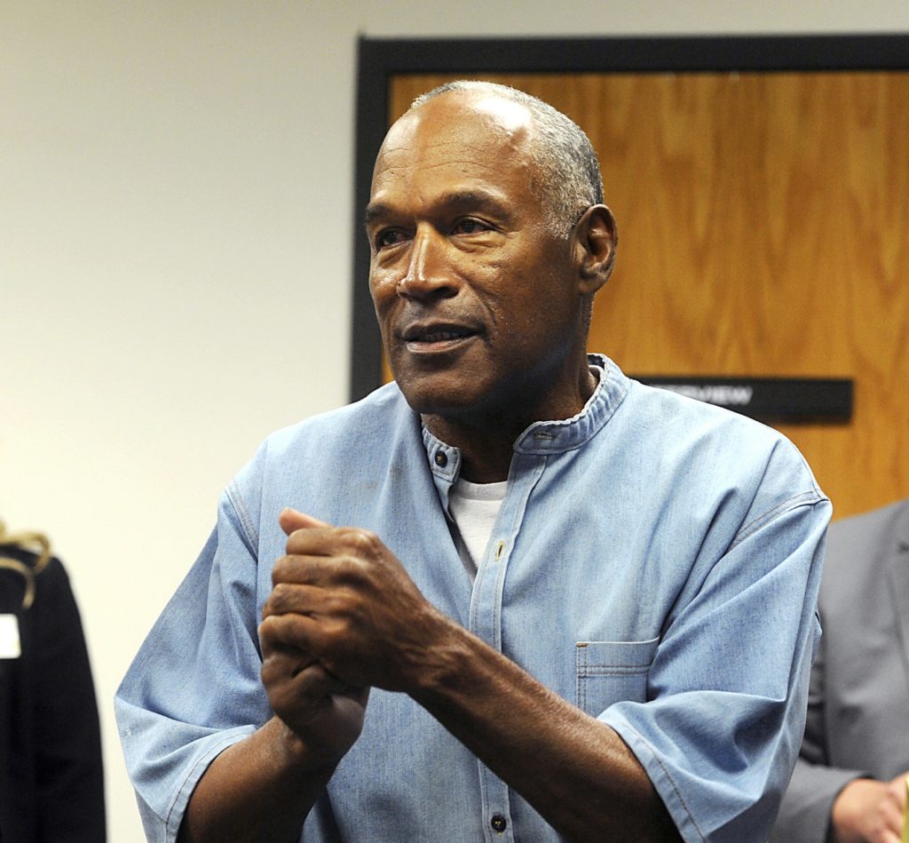 FILE - In this July 20, 2017 file photo, former NFL football star O.J. Simpson reacts after learning he was granted parole during a hearing at the Lovelock Correctional Center in Lovelock, Nev. Simpson was granted parole after more than eight years in prison for a Las Vegas hotel heist. A Nevada prison official said early Sunday, Oct. 1, 2017, O.J. Simpson, the former football legend and Hollywood star, has been released from a Nevada prison in Lovelock after serving nine years for armed robbery.  (Jason Bean/The Reno Gazette-Journal via AP, Pool, File)