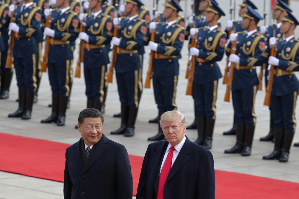 U.S. President Donald Trump, right, walks with Chinese President Xi Jinping during a welcome ceremony at the Great Hall of the people in Beijing, Thursday, Nov. 9, 2017. (AP Photo/Andy Wong)