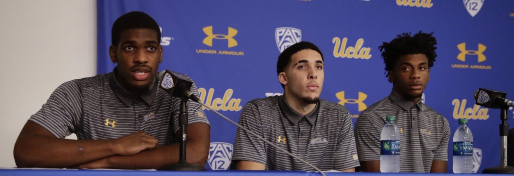 UCLA basketball player Cody Riley, left, reads his statement as he is joined by teammates LiAngelo Ball, center, and Jalen Hill during a news conference at UCLA Wednesday, Nov. 15, 2017, in Los Angeles. Three UCLA NCAA college basketball players accused of shoplifting in China admitted to the crime and apologized before coach Steve Alford announced they were being suspended indefinitely. (AP Photo/Jae C. Hong)