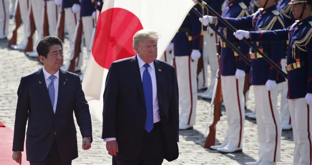 U.S. President Donald Trump reviews an honor guard during a welcome ceremony, escorted by Japanese Prime Minister Shinzo Abe at Akasaka Palace in Tokyo, Monday, Nov. 6, 2017. (AP Photo/Koji Sasahara, Pool)