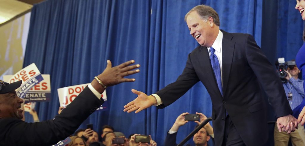 Doug Jones is greeted by a supporter before speaking during an election-night watch party Tuesday, Dec. 12, 2017, in Birmingham, Ala. Jones has defeated Republican Roy Moore, a one-time GOP pariah who was embraced by the Republican Party and the president even after facing allegations of sexual impropriety. (AP Photo/John Bazemore)