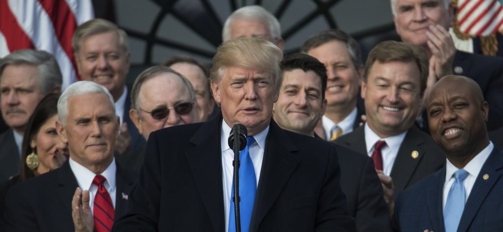 President Donald Trump, joined by Vice President Mike Pence, Speaker of the House Paul Ryan, R-Wis., and other members of congress, pauses as he speaks during an event on the South Lawn of the White House in Washington, Wednesday, Dec. 20, 2017, to acknowledge the final passage of tax overhaul legislation by Congress. (AP Photo/Carolyn Kaster)