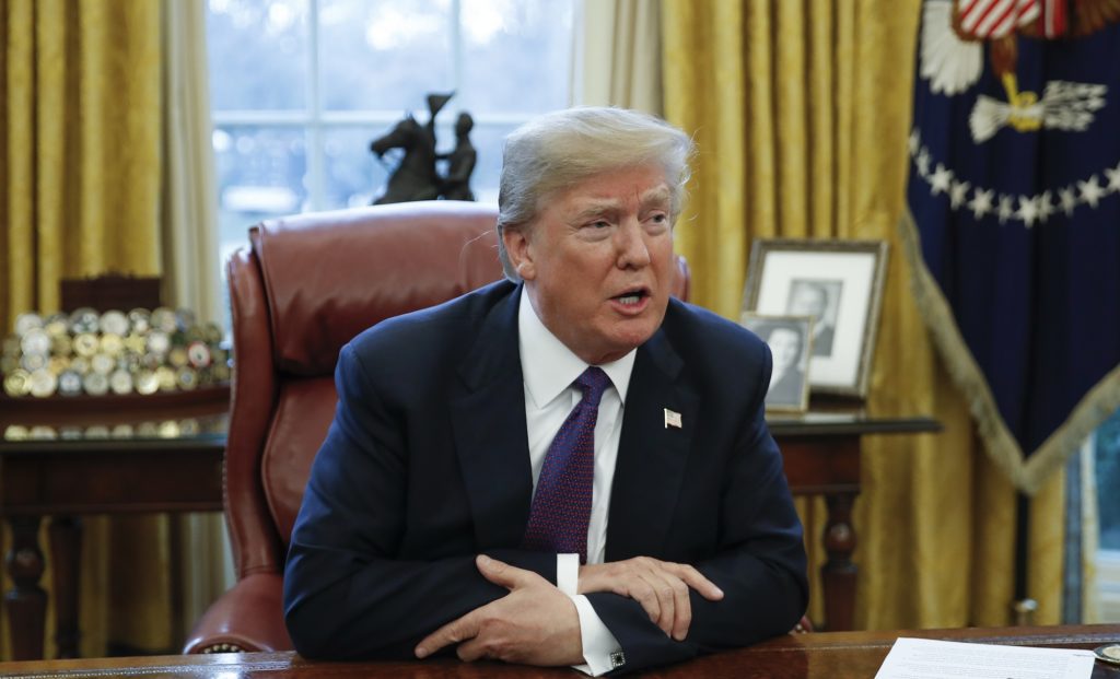 President Donald Trump speaks to media after signing Section 201actions in the Oval Office of the White House in Washington, Tuesday, Jan. 23, 2018. Trump says he is imposing new tariffs to "protect American jobs and American workers." Trump acted to impose new tariffs on imported solar-energy components and large washing machines in a bid to help U.S. manufacturers. (AP Photo/Carolyn Kaster)