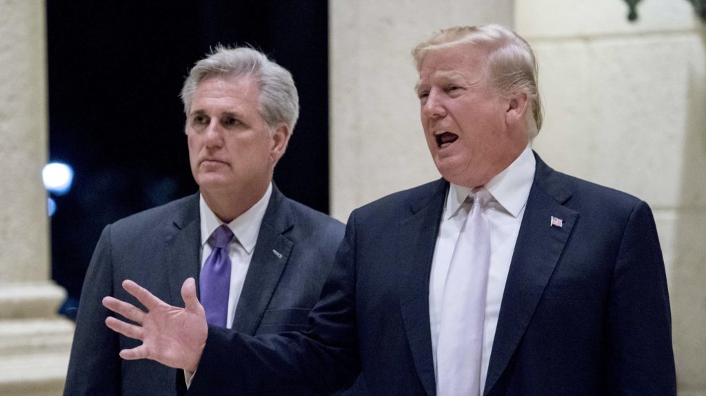 President Donald Trump, right, accompanied by House Majority Leader Kevin McCarthy, R-Calif., speaks to members of the media as they arrive for a dinner at Trump International Golf Club in West Palm Beach, Fla., Sunday, Jan. 14, 2018. (AP Photo/Andrew Harnik)