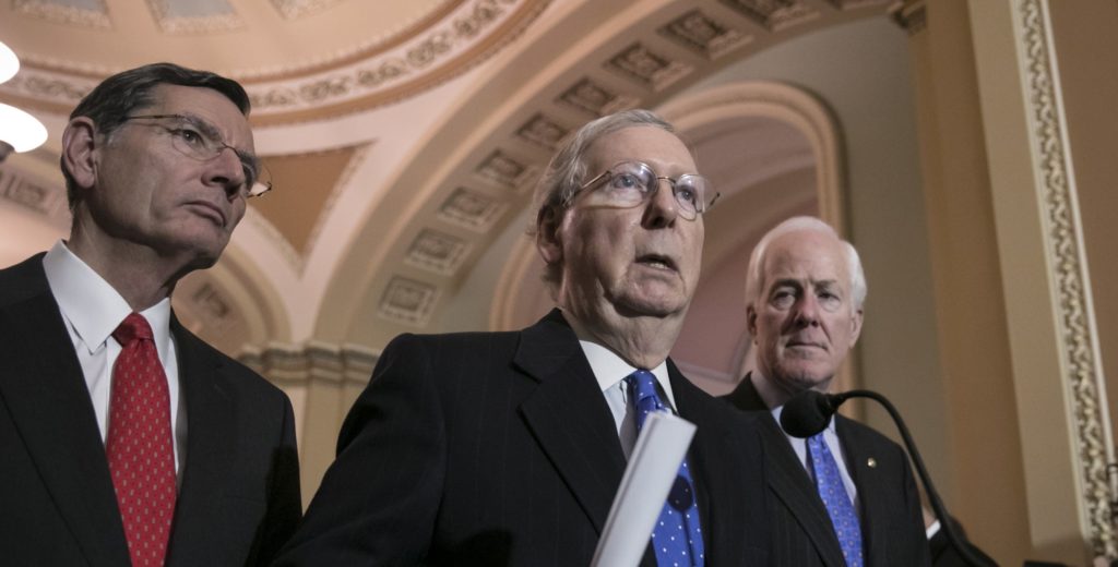 Senate Majority Leader Mitch McConnell, R-Ky., flanked by Sen. John Barrasso, R-Wyo., left, and Majority Whip John Cornyn, R-Texas, speaks to reporters about efforts to avoid a government shutdown this weekend, at the Capitol in Washington, Wednesday, Jan. 17, 2018. (AP Photo/J. Scott Applewhite)