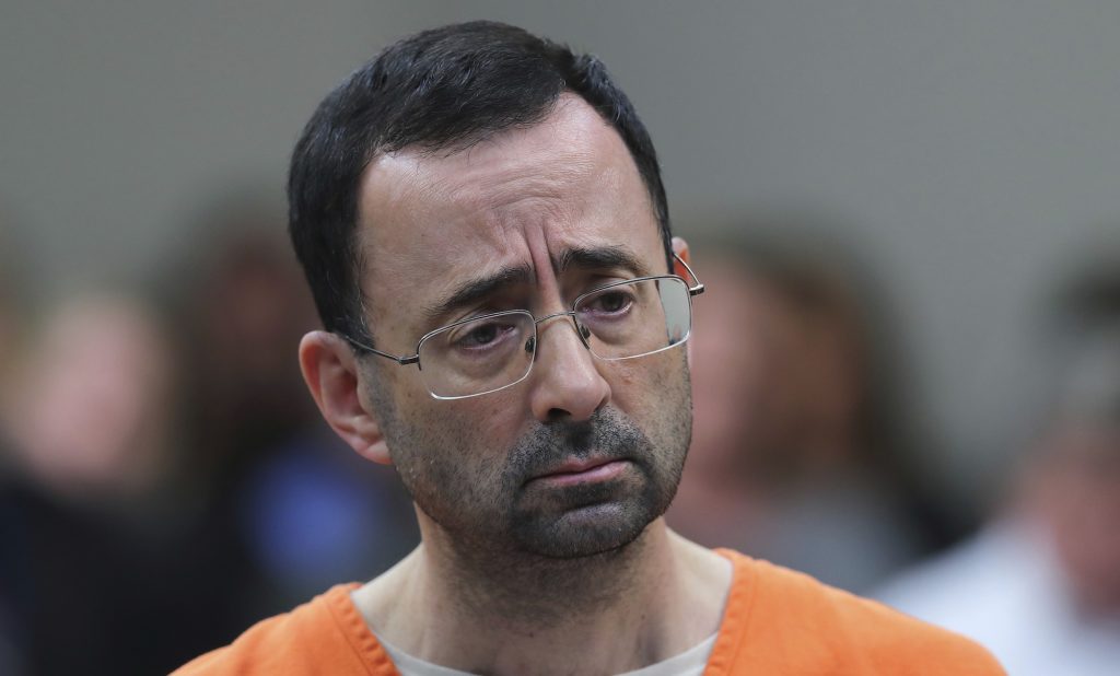 In this Nov. 22, 2017 file photo, Dr. Larry Nassar, 54, appears in court for a plea hearing in Lansing, Mich. Nasser, a sports doctor accused of molesting girls while working for USA Gymnastics and Michigan State University pleaded, guilty to multiple charges of sexual assault and will face at least 25 years in prison.(AP Photo/Paul Sancya)