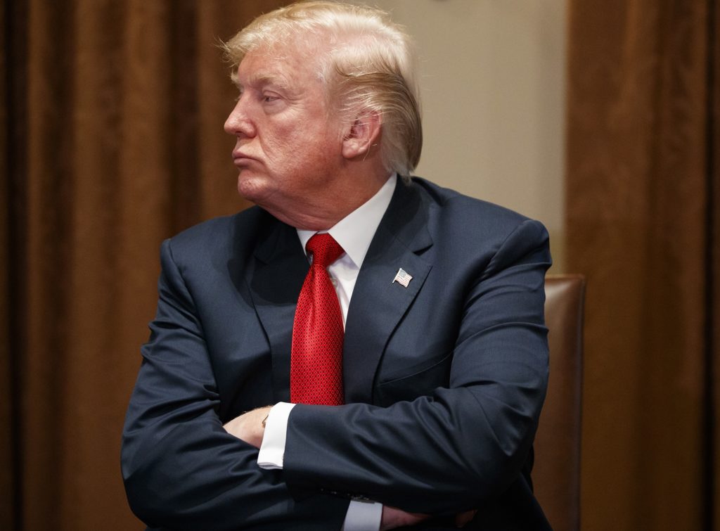 President Donald Trump listens during a meeting with law enforcement officials on the MS-13 street gang and border security, in the Cabinet Room of the White House, Tuesday, Feb. 6, 2018, in Washington. (AP Photo/Evan Vucci)