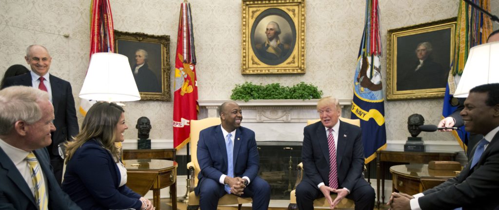 President Donald Trump, with Sen. Tim Scott, R-S.C., center left, participates in a working session regarding the opportunity zones provided by tax reform in the Roosevelt Room of the White House, Wednesday, Feb. 14, 2018, in Washington. (AP Photo/Manuel Balce Ceneta)