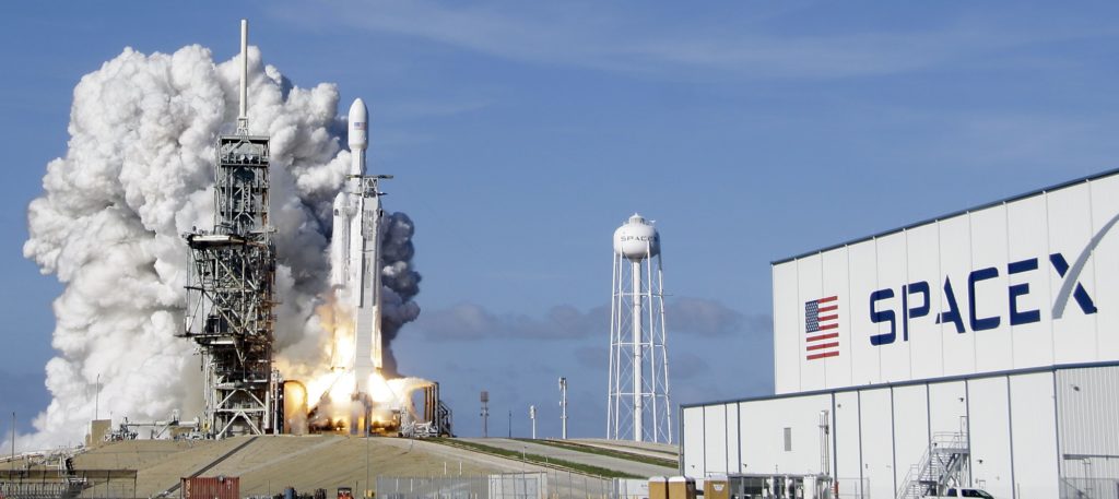 A Falcon 9 SpaceX heavy rocket lifts off from pad 39A at the Kennedy Space Center in Cape Canaveral, Fla., Tuesday, Feb. 6, 2018. The Falcon Heavy, has three first-stage boosters, strapped together with 27 engines in all. (AP Photo/John Raoux)