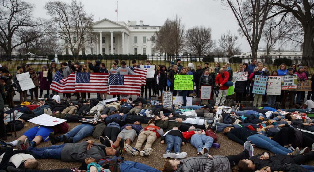 Demonstrators participate in a "lie-in" during a protest in favor of gun control reform in front of the White House, Monday, Feb. 19, 2018, in Washington. (AP Photo/Evan Vucci)