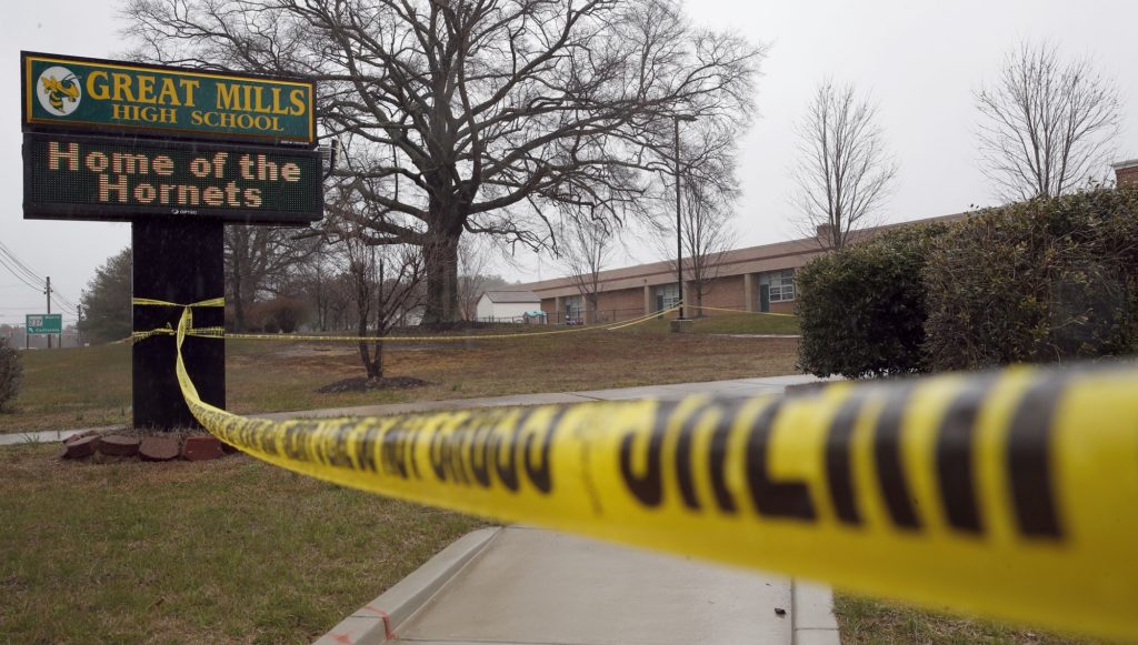 Crime scene tape is used around Great Mills High School, the scene of a shooting, Tuesday, March 20, 2018, in Great Mills. A student with a handgun shot two classmates inside the school before he was fatally wounded during a confrontation with a school resource officer, a sheriff said. (AP Photo/Alex Brandon)