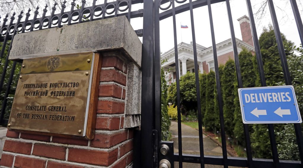 A metal fence surrounds the residence of Russia's consul general Monday, March 26, 2018, in Seattle. The United States and more than a dozen European nations kicked out Russian diplomats on Monday and the Trump administration ordered Russia's consulate in Seattle to close, as the West sought joint punishment for Moscow's alleged role in poisoning an ex-spy in Britain. (AP Photo/Elaine Thompson)