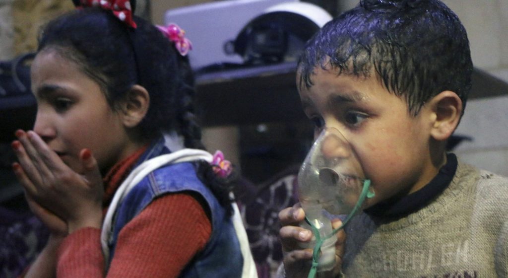 This image released early Sunday, April 8, 2018 by the Syrian Civil Defense White Helmets, shows a child receiving oxygen through respirators following an alleged poison gas attack in the rebel-held town of Douma, near Damascus, Syria. Syrian rescuers and medics said the attack on Douma killed at least 40 people. The Syrian government denied the allegations, which could not be independently verified. The alleged attack in Douma occurred Saturday night amid a resumed offensive by Syrian government forces after the collapse of a truce. (Syrian Civil Defense White Helmets via AP)