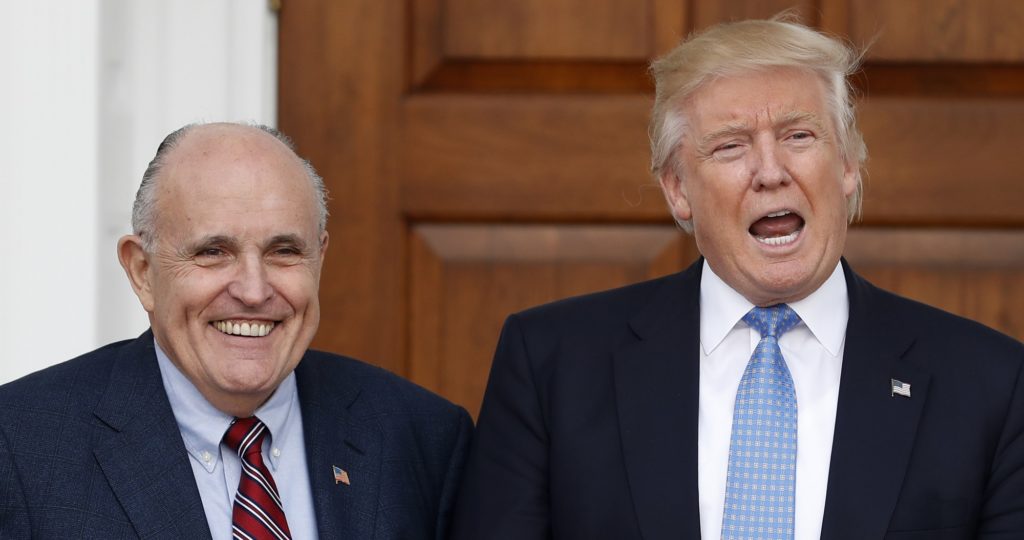 President-elect Donald Trump calls out to media as he and former New York Mayor Rudy Giuliani pose for photographs as Giuliani arrives at the Trump National Golf Club Bedminster clubhouse, Sunday, Nov. 20, 2016, in Bedminster, N.J.. (AP Photo/Carolyn Kaster)