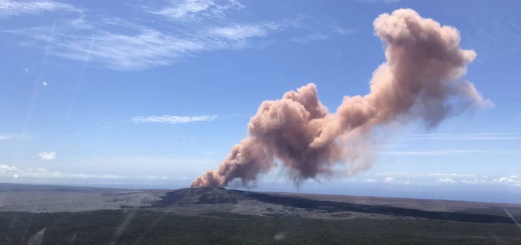 In this photo released by U.S. Geological Survey, ash plume rises above the Puu Oo vent, on Hawaii's Kilaueaa Volcano Thursday, May 3, 2018 in Hawaii Volcanoes National Park. Nearly 1,500 residents were ordered to evacuate from their volcano-side homes after Hawaii's Kilauea Volcano erupted, sending molten lava to chew its way through forest land and bubble up on paved streets. (U.S. Geological Survey via AP)