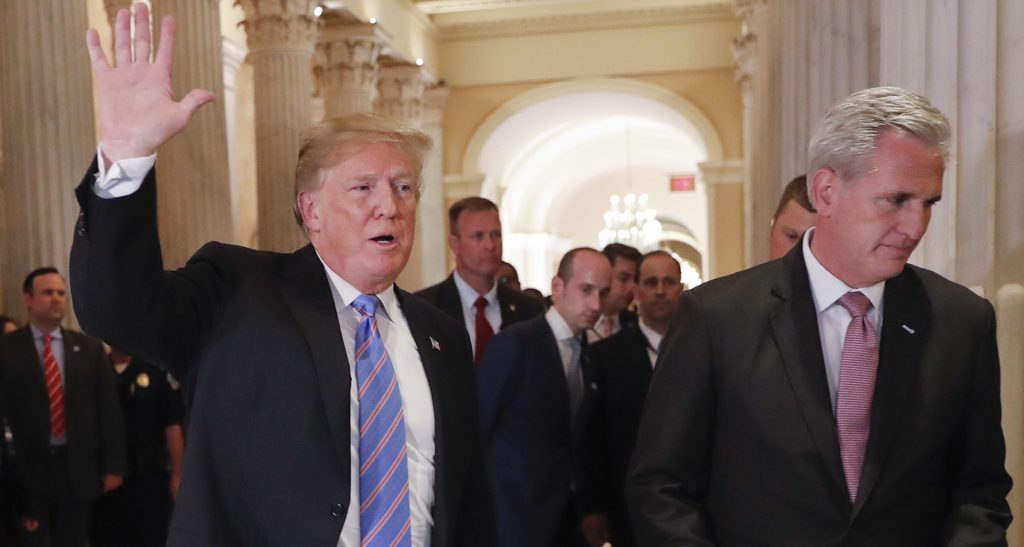 President Donald Trump, left, gestures as he walks with House Majority Leader Kevin McCarthy of Calif., right, while leaving the U.S. Capitol in Washington after meeting with GOP leadership, Tuesday, June 19, 2018. Walking behind them is Stephen Miller, center, White House senior adviser. (AP Photo/Pablo Martinez Monsivais)