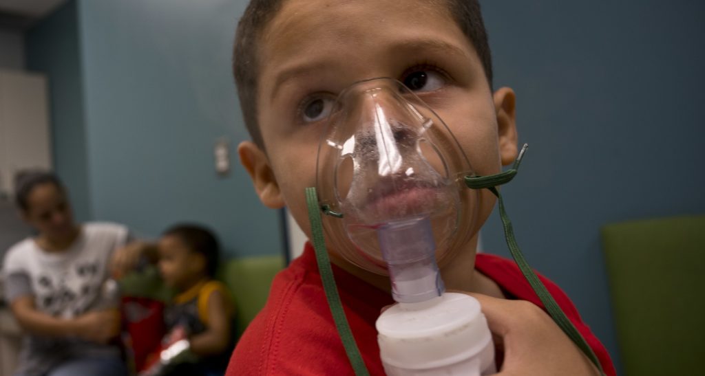 In this May 29, 2018 photo, Yahir Garcia receives one of his two daily treatments for asthma at a medical center in San Juan, Puerto Rico. Garcia is one of many that doctors say are struggling to breathe asthma cases in the U.S. territory spike in the aftermath of the Category 4 storm, raising concerns about deteriorating health conditions on an island struggling to prepare for a new hurricane season. (AP Photo/Ramon Espinosa)