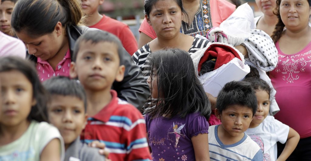 Immigrant families line up to enter the central bus station after they were processed and released by U.S. Customs and Border Protection, Sunday, June 24, 2018, in McAllen, Texas. (AP Photo/David J. Phillip)