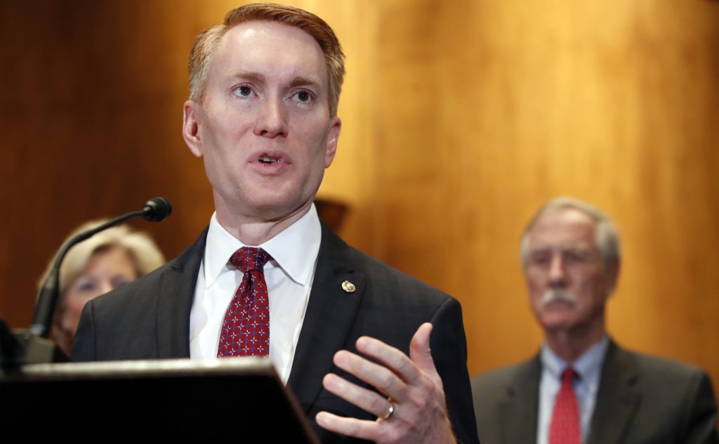 Sen. James Lankford, R-Okla., left, with Sen. Angus King, I-Maine, right, speaks about immigration and the Deferred Action for Childhood Arrivals (DACA) program Wednesday, Feb. 7, 2018, on Capitol Hill in Washington. (AP Photo/Jacquelyn Martin)