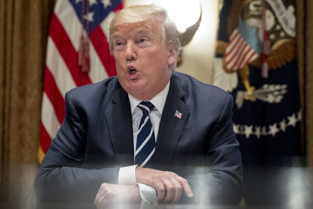 President Donald Trump speaks to members of the media as he meets with members of Congress in the Cabinet Room of the White House, Tuesday, July 17, 2018, in Washington. Trump says he meant the opposite when he said in Helsinki that he doesn't see why Russia would have interfered in the 2016 U.S. elections. (AP Photo/Andrew Harnik)