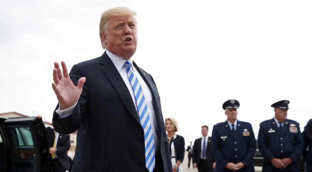 President Donald Trump speaks to the media after he steps off Air Force One, Tuesday, Aug. 21, 2018, in Charleston, W.Va. Trump says the conviction of his former campaign chairman Paul Manafort on financial crimes is "a disgrace." (AP Photo/Alex Brandon)
