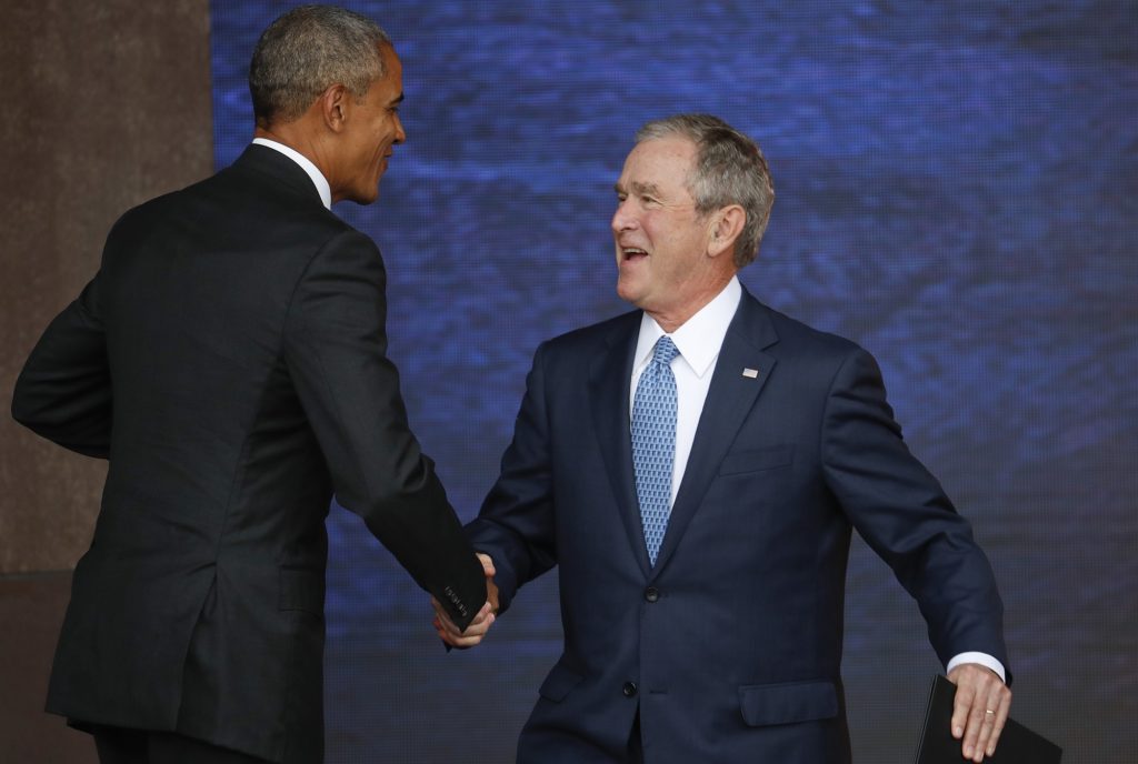 President Barack Obama, left, and former President George W. Bush, right, shake hands following Bush's speech at the dedication ceremony for the Smithsonian Museum of African American History and Culture on the National Mall in Washington, Saturday, Sept. 24, 2016. (AP Photo/Pablo Martinez Monsivais)
