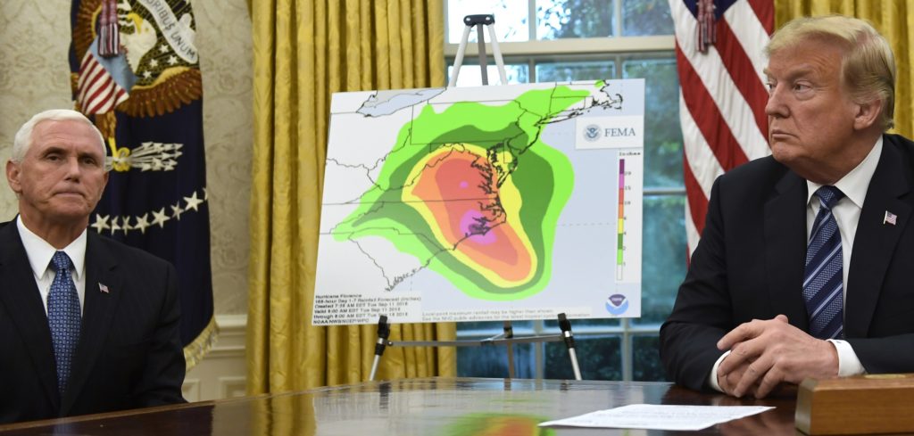 President Donald Trump, right, and Vice President Mike Pence, left, listen during a briefing on Hurricane Florence in the Oval Office of the White House in Washington, Tuesday, Sept. 11, 2018. (AP Photo/Susan Walsh)