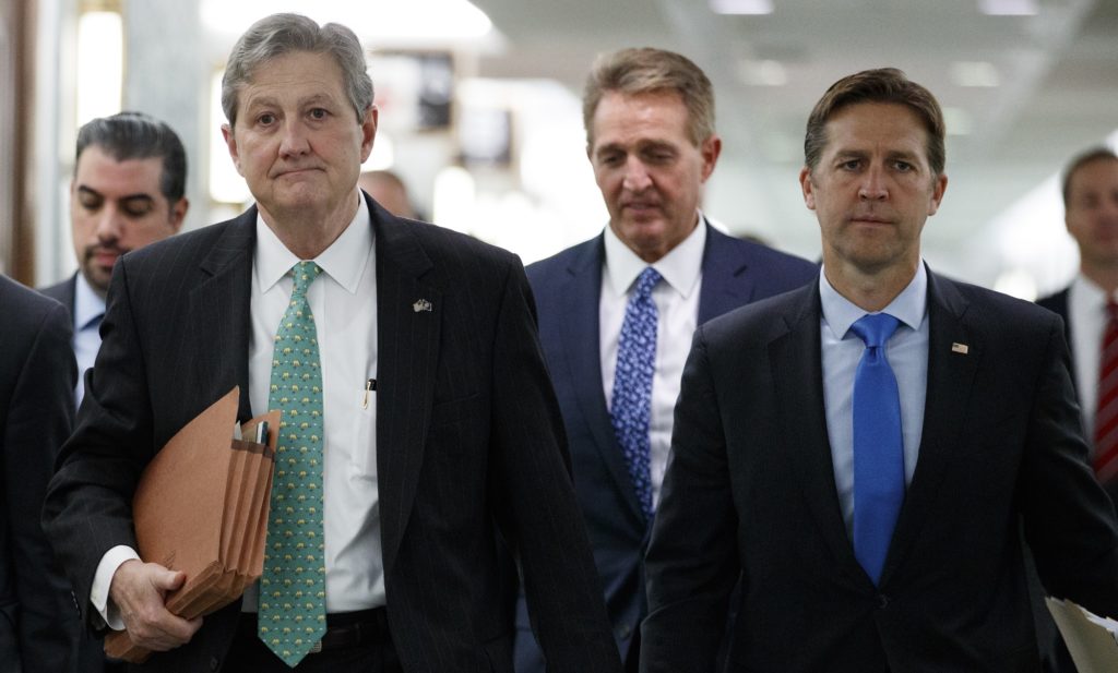 Senate Judiciary Committee members Sen. John Kennedy, R-La., left, Sen. Ben Sasse, R-Neb., right, and Sen. Jeff Flake, R-Ariz., center, arrive for the Senate Judiciary Committee hearing on Capitol Hill in Washington, Thursday, Sept. 27, 2018, with Christine Blasey Ford and Supreme Court nominee Brett Kavanaugh. (AP Photo/Carolyn Kaster)