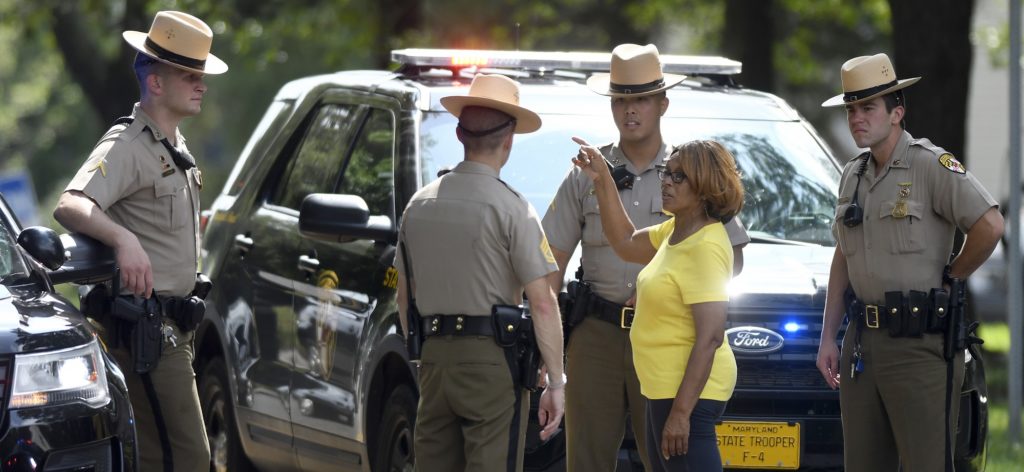 JoWanda Strickland- Lucas, of Aberdeen, Md., speaks to Maryland State Police near the perimeter of a scene where a shooting took place in Aberdeen, Md. on Thursday, Sept. 20, 2018. (AP Photo/Steve Ruark)