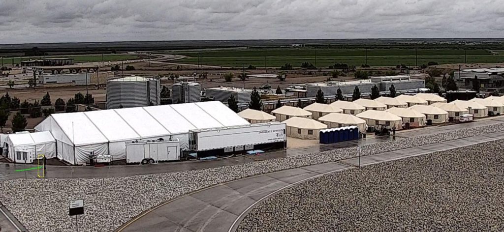 FILE - This undated file photo provided by HHS' Administration for Children and Families shows the shelter used to house unaccompanied foreign children in Tornillo, Texas. The U.S. government says the West Texas tent shelter will remain open through the end of the year. A spokesman for the U.S. Department of Health and Human Services said Tuesday, Sept. 11, 2018, that the facility will be expanded to 3,800 beds from its initial capacity of 360 beds. (HHS' Administration for Children and Families via AP, File)