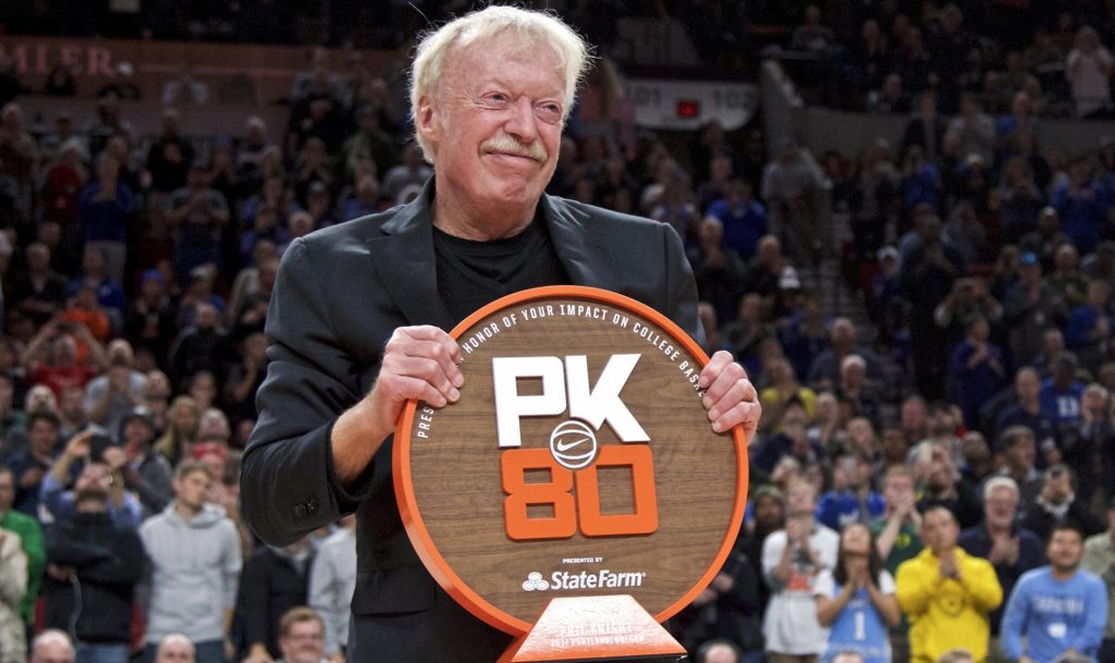 Nike co-founder Phil Knight is presented with a plaque during the first half of an NCAA college basketball game between Duke and Florida in the Phil Knight Invitational tournament in Portland, Ore., Sunday, Nov. 26, 2017. (AP Photo/Craig Mitchelldyer)