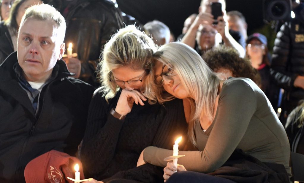 Family members and friends gather for a candlelight vigil memorial at Mohawk Valley Gateway Overlook Pedestrian Bridge in Amsterdam, N.Y., Monday, Oct. 8, 2018. The memorial honored 20 people who died in Saturday's fatal limousine crash in Schoharie, N.Y. (AP Photo/Hans Pennink)