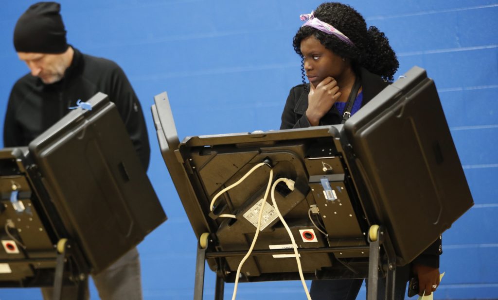 A voter waits for assistance from a volunteer at the Tuttle Park Recreation Center, Tuesday, Nov. 6, 2018, in Columbus, Ohio. Across the country, voters headed to the polls Tuesday in one of the most high-profile midterm elections in years. (AP Photo/John Minchillo)