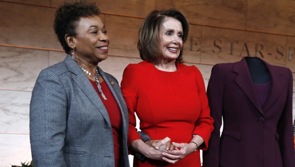 House Minority Leader Nancy Pelosi of Calif., right, stands with Rep. Barbara Lee, D-Calif., during a donation ceremony at the Smithsonian's National Museum of American History Wednesday, March 7, 2018. Pelosi donated items including her gavel, a burgundy dress she wore to her swearing in, and the original speech she gave from January 4, 2007. Next to the dress Pelosi donated is a dress worn by Marian Anderson, who was the first African American to perform with the Metropolitan Opera, when she performed at the Lincoln Memorial in 1939. Pelosi was the first woman Speaker of the House. (AP Photo/Jacquelyn Martin)
