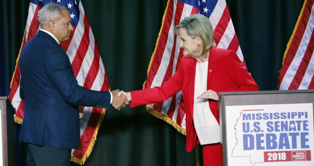 Appointed U.S. Sen. Cindy Hyde-Smith, R-Miss., and Democrat Mike Espy greet each other before their televised Mississippi U.S. Senate debate in Jackson, Miss., Tuesday, Nov. 20, 2018. (AP Photo/Rogelio V. Solis, Pool)