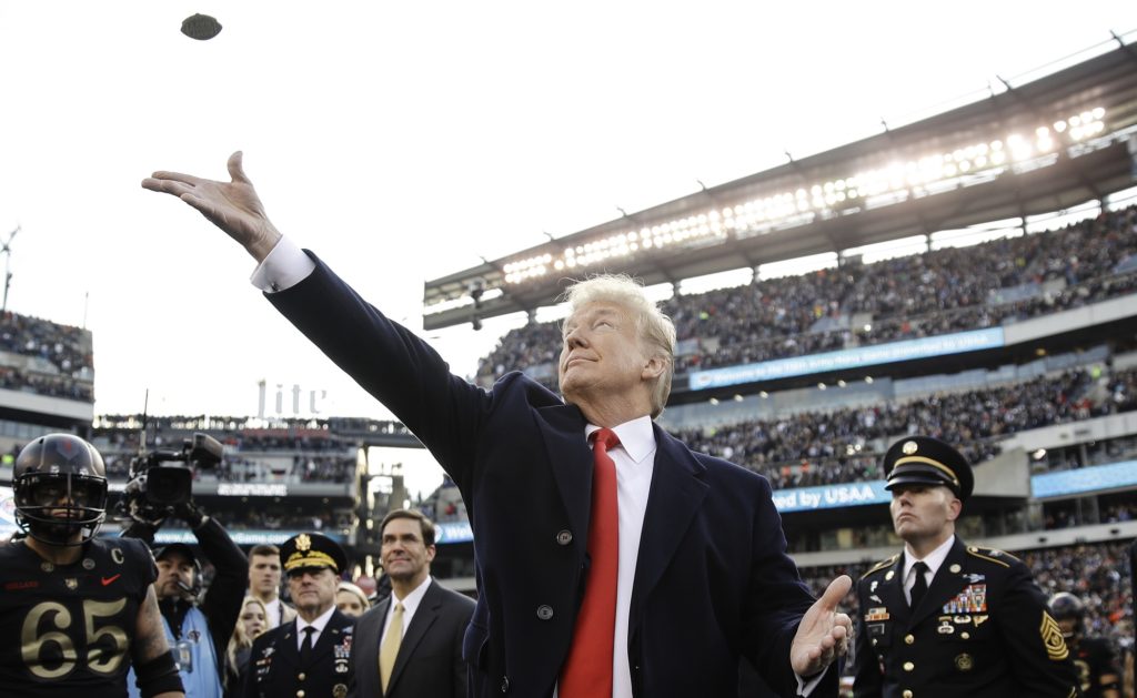 President Donald Trump tosses the coin before the Army-Navy NCAA college football game Saturday, Dec. 8, 2018, in Philadelphia. (AP Photo/Matt Rourke)