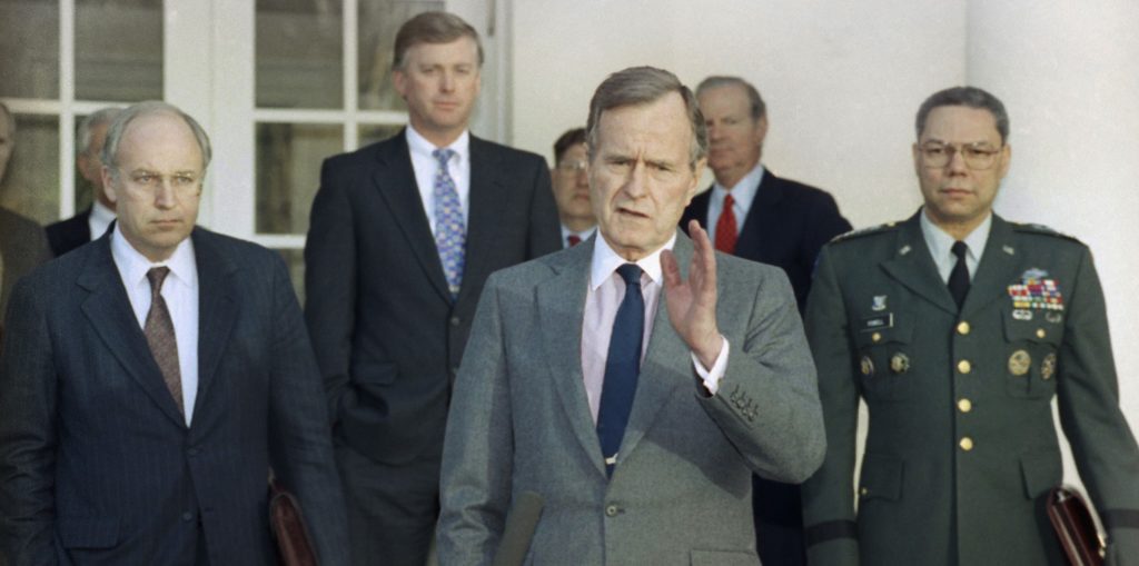 FILE - In this Feb. 11, 1991, file photo, President George H.W. Bush talks to reporters in the Rose Garden of the White House after meeting with top military advisors to discuss the Persian Gulf War. From left are, Defense Secretary Dick Cheney, Vice President Dan Quayle, White House Chief of Staff John Sununu, the president, Secretary of State James A. Baker III, and Joint Chiefs Chairman Gen. Colin Powell. Bush died at the age of 94 on Friday, Nov. 30, 2018, about eight months after the death of his wife, Barbara Bush. (AP Photo/Ron Edmonds, File)