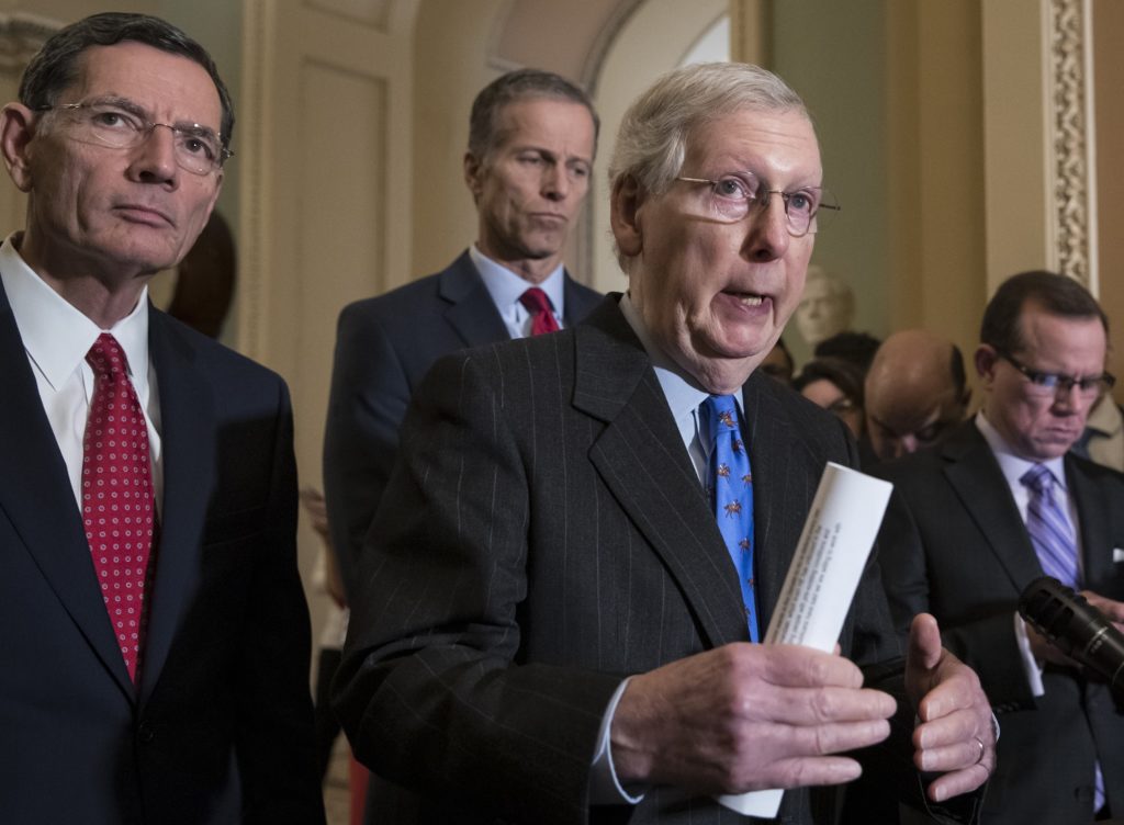 Senate Majority Leader Mitch McConnell, R-Ky., center, joined from left by Sen. John Barrasso, R-Wyo., and Sen. John Thune, R-S.D., speaks to reporters about the possibility of a partial government shutdown, at the Capitol in Washington, Tuesday, Dec. 18, 2018. Congress and President Donald Trump continue to bicker over his demand that lawmakers fund a wall along the U.S.-Mexico border, pushing the government to the brink of a partial shutdown at midnight Friday. (AP Photo/J. Scott Applewhite)