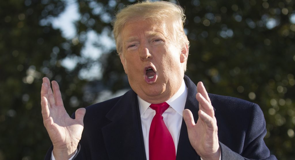 President Donald Trump speaks on the South Lawn of the White House as he walks to Marine One, Sunday, Jan. 6, 2019, in Washington. Trump is en route to Camp David. (AP Photo/Alex Brandon)