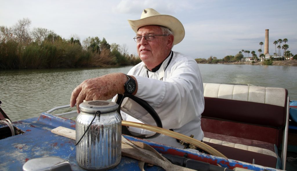In this Tuesday, Jan. 8, 2019 photo, father Roy Snipes, pastor of the La Lomita Chapel, shows Associated Press journalists the land on either side of the Rio Grande at the US-Mexico border in Mission, Texas. Portions of Father Snipes' church land in Mission could be seized by the federal government to construct additional border wall and fence lines. Rather than surrender their land to the federal government, some property owners on the Texas border are digging in to fight President Donald Trump's border wall. They are rejecting buyout offers and preparing to battle the administration in court. Trump is scheduled to travel to the border Thursday to make the case for his $5.7 billion wall. (AP Photo/John L. Mone)